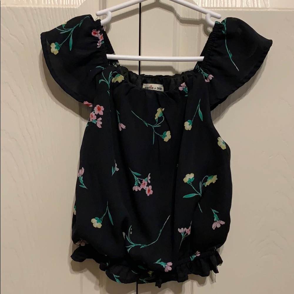 Girls blouse with flower detail.